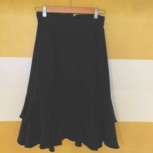 Black, silk vintage ruffle salsa skirt. Fits pencil like into bottom ruffle.